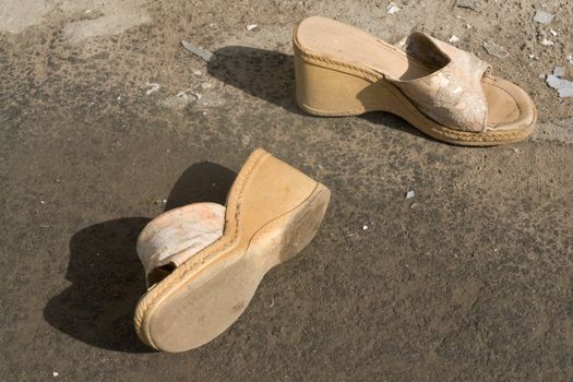 a dilapidated pair of woman's shoes