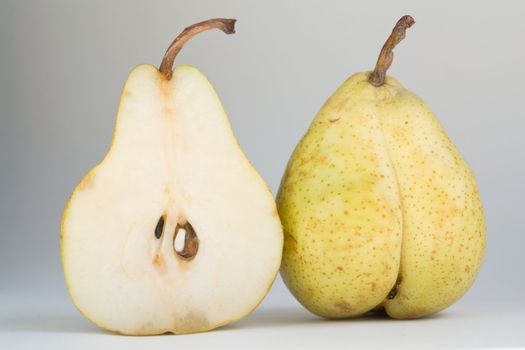 Open and closed pear on a white background