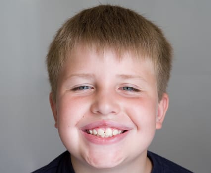 Portrait of a boy with a pleased smile upon one's face