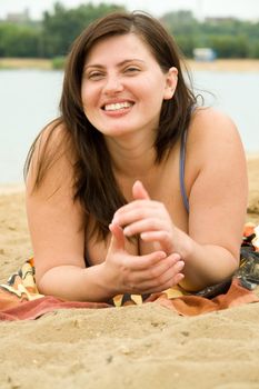 The young beautiful woman on a beach