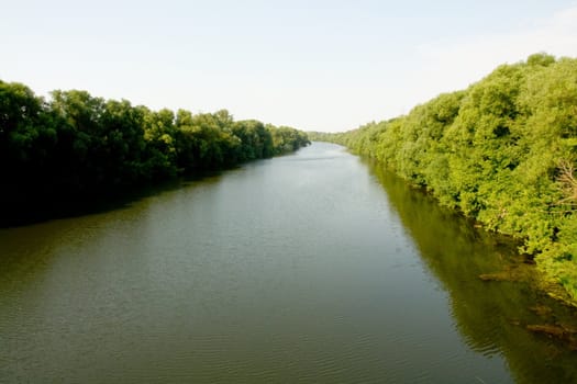 Perspective. The small river flows to horizon.