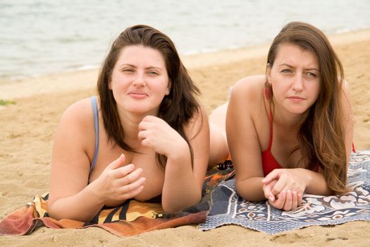 Two young pretty women on a beach