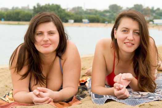 Two young pretty women on a beach