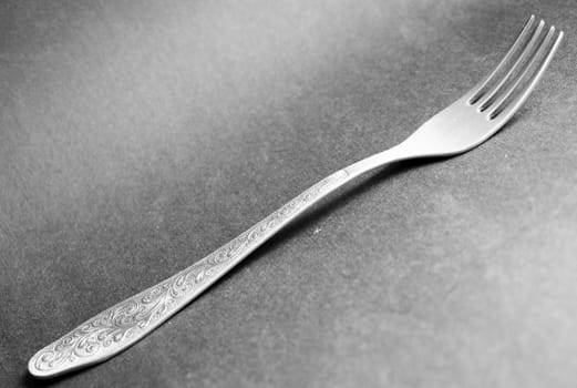 silver dinner fork on a grey background