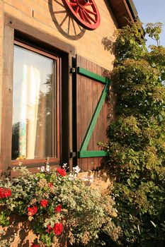 Flower box on the house window with shutters – Belgian village