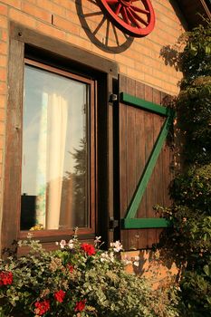 Flower box on the house window with shutters – Belgian village