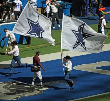 DALLAS - OCT 5: Taken in Texas Stadium in Irving, Texas on Sunday, October 5, 2008. Two men celebrate with flags after the Dallas Cowboys score a touchdown. The last season that the Cowboys will play in Texas Stadium. 
