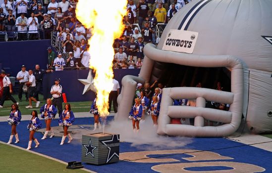 DALLAS - OCT 5: Taken in Texas Stadium in Irving, Texas on Sunday, October 5, 2008 during pregame activities. The Dallas Cowboys cheerleaders enter the field as pyrotechnics are displayed. The last season that the Cowboys will play in Texas Stadium. 
