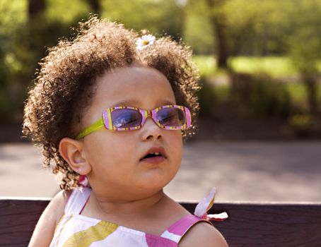 Young black baby girl with glasses