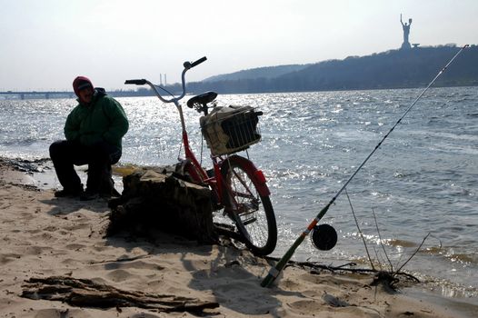 Sillhouette of a man fishing                                