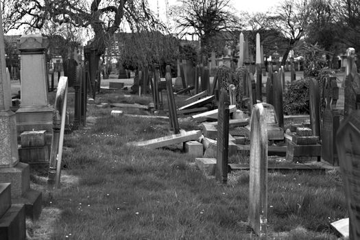 Rows of broken tombstones in a graveyard