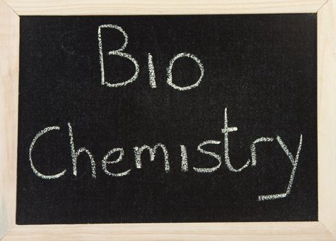 A black board with a wooden frame and the words 'BIOCHEMISTRY' written in chalk.