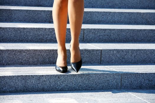 Woman stepping down on stairway in city