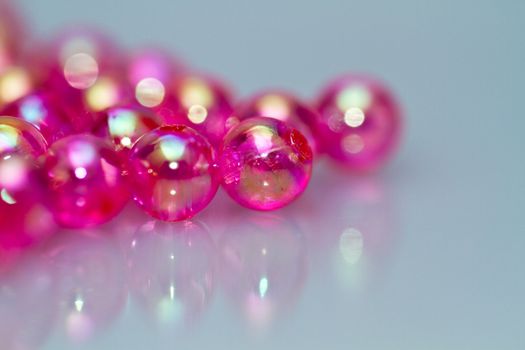 red beads on bluish white surface for background