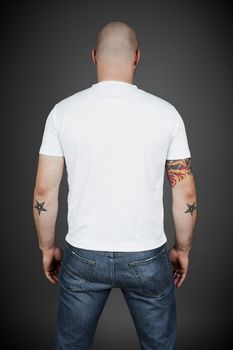 A back side of a young man in a white shirt
