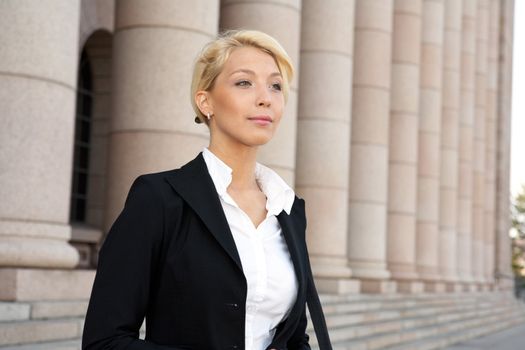 Portrait of young businesswoman outside building