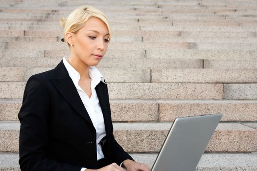 Young businesswoman working remotely with laptop computer 