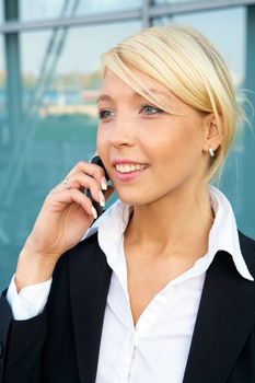 Young businesswoman using mobile phone, portrait