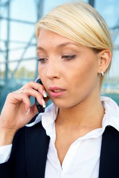 Young businesswoman using mobile phone, looking down