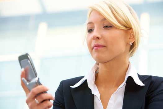 Young businesswoman looking at  mobile phone