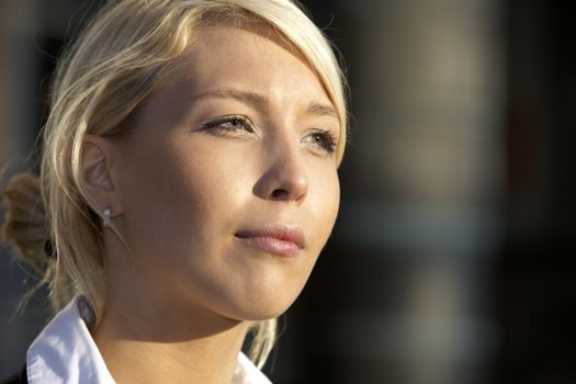 Close-up of young businesswoman contemplating outdoors