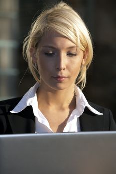 Close-up of young businesswoman working with laptop computer