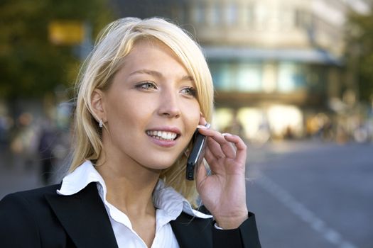 Young businesswoman using mobile phone in city