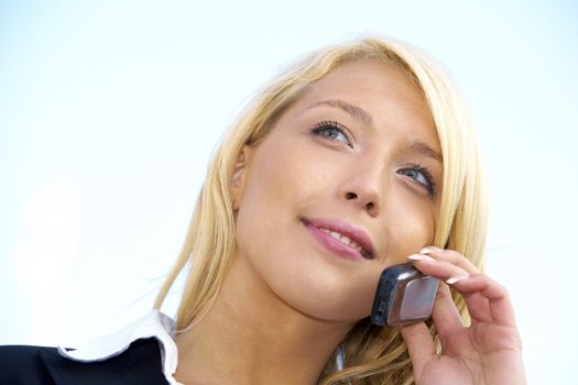 Close-up of young businesswoman using mobile phone outdoors