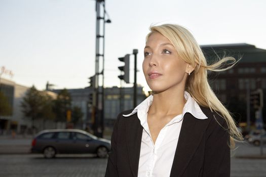 Portait of young businesswoman in city at night