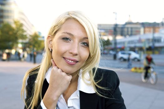 Young businesswoman smiling looking at camera in street