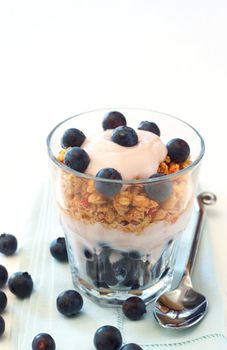 Healthy breakfast with muesli, yogurt and blueberries in a glass