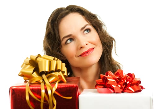 Beautiful young woman choosing christmas presents. Isolated over white.