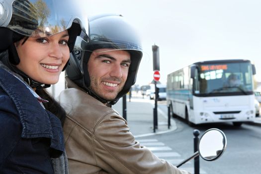 Couple on scooter at a crossroad