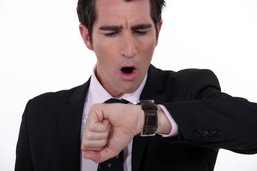 businessman in a hurry looking at his watch