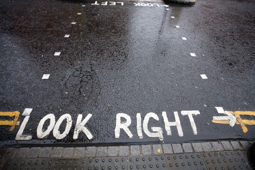 Look Right warning painted on street at a pedestrian zebra crossing in a London, United Kingdom