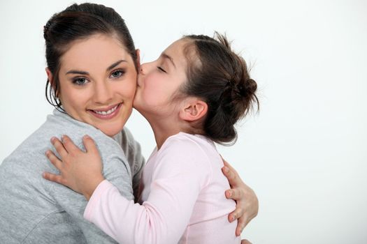 Daughter kissing her mum