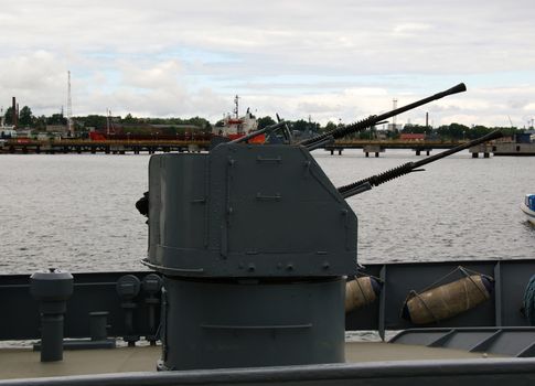  gun is on a military ship on deck