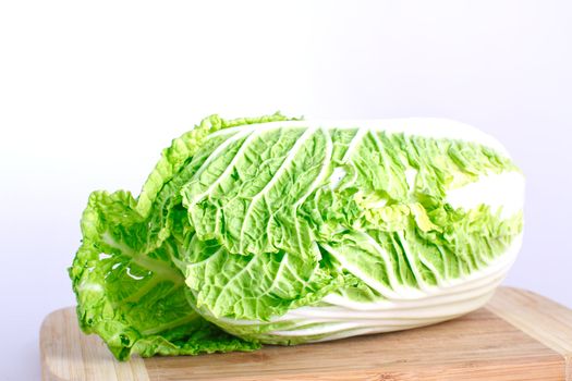 Fresh cabbage on the wood desk isolated on the white background