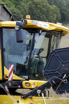 the harvest of colza with machines like a reaping-machine threshing-machine and tractor