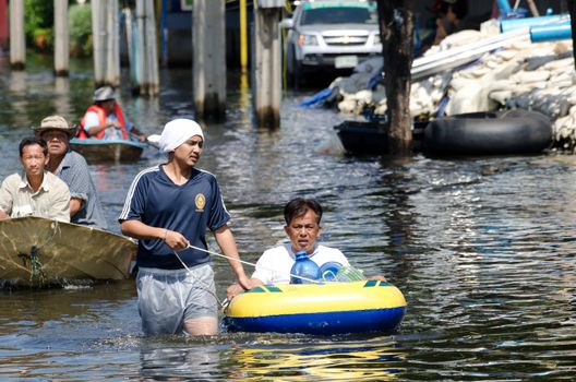 BANGKOK, THAILAND-NOVEMBER 13: Transportation of people in the streets flooded after the heaviest monsoon rain in 50 years in the capital on November 13, 2011 Phahon Yothin Road, bangkok, Thailand.