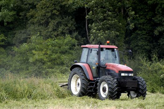 the harvest of colza with machines like a reaping-machine threshing-machine and tractor