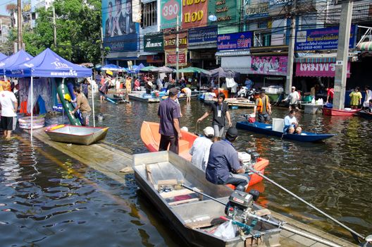 BANGKOK, THAILAND-NOVEMBER 13: Transportation of people in the streets flooded after the heaviest monsoon rain in 50 years in the capital on November 13, 2011 Phahon Yothin Road, bangkok, Thailand.