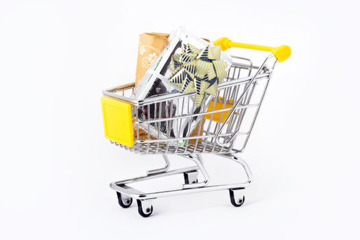 Gifts in a shopping-cart on a white background