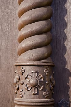 Wooden carved home column. Brown painted architectural detail.