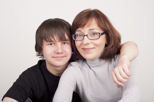 mother and son are together and smile in studio