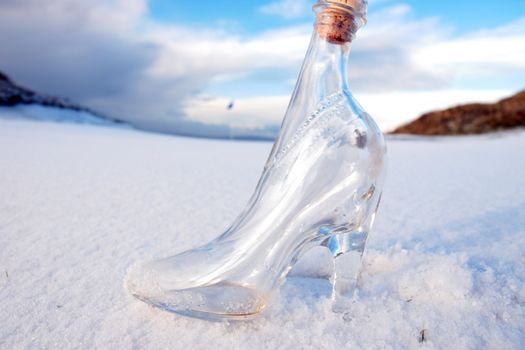 a glass slipper in a snow covered irish golf course for a concept on ladies golf