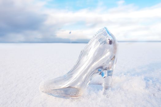 a glass slipper in a snow covered irish golf course for a concept on ladies golf