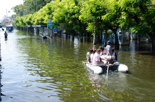 BANGKOK, THAILAND-NOVEMBER 13: Transportation of people in the streets flooded after the heaviest monsoon rain in 50 years in the capital on November 13, 2011 Phahon Yothin Road, bangkok, Thailand.