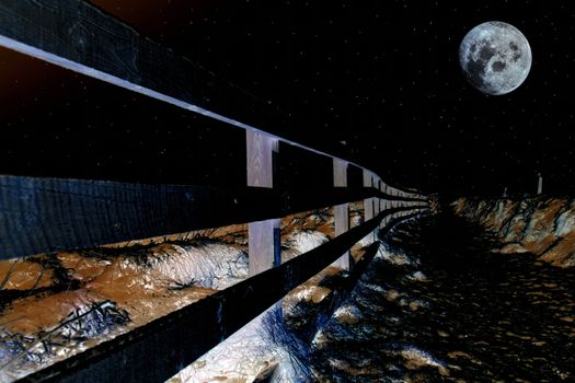 frosty winters night view at ballybunion cliffside walk with bright moon and fence