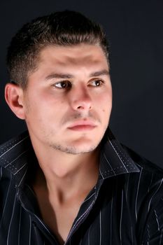 Male model in studio against black background